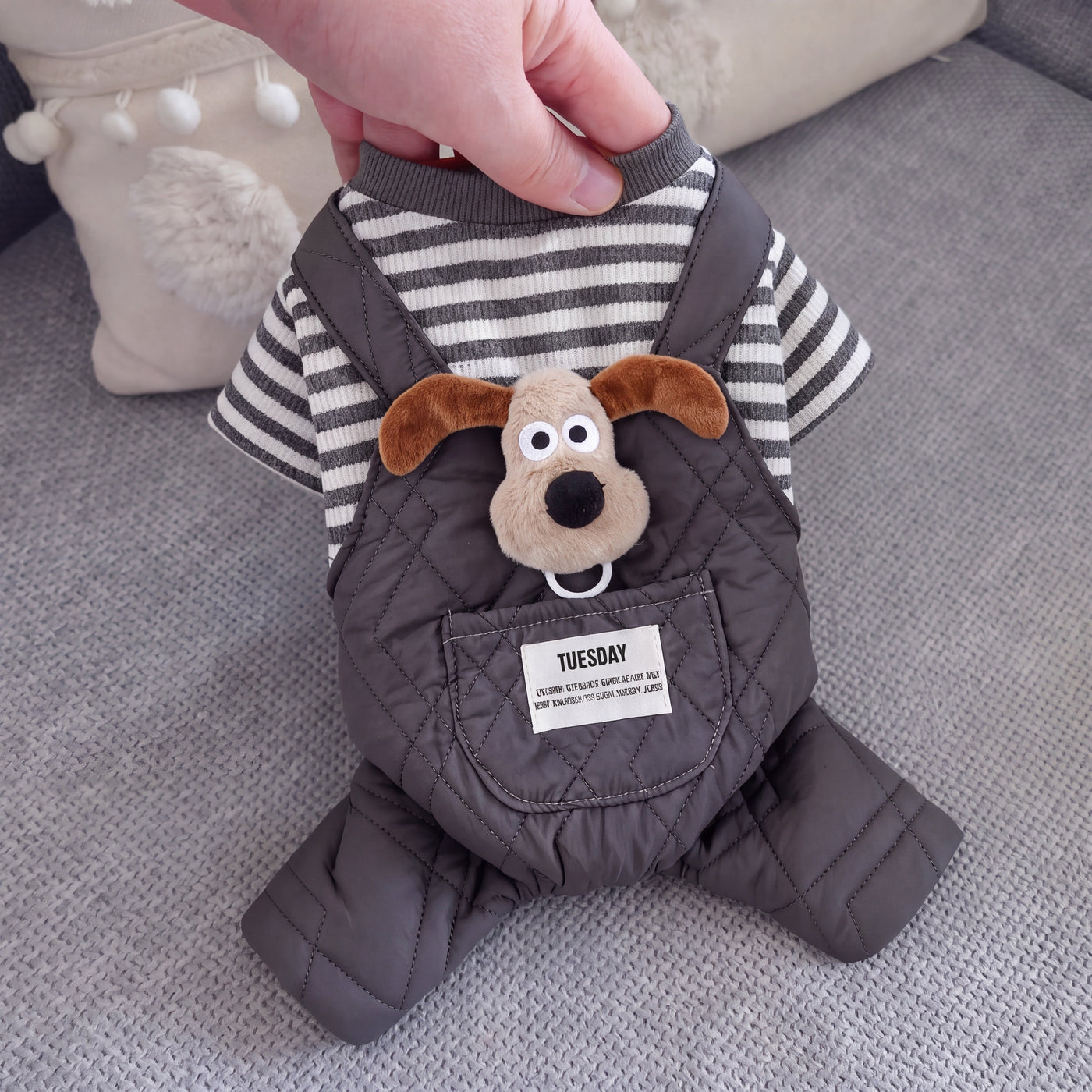 Baby Pluto dog suit grey held up by hand close-up – Malpetit