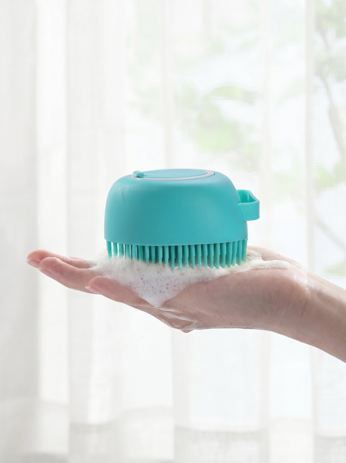 Silicone bath brush in hand with shampoo foam – Malpetit